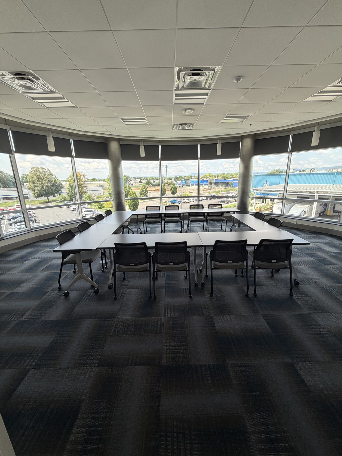 A plant office conference room with windows overlooking the site