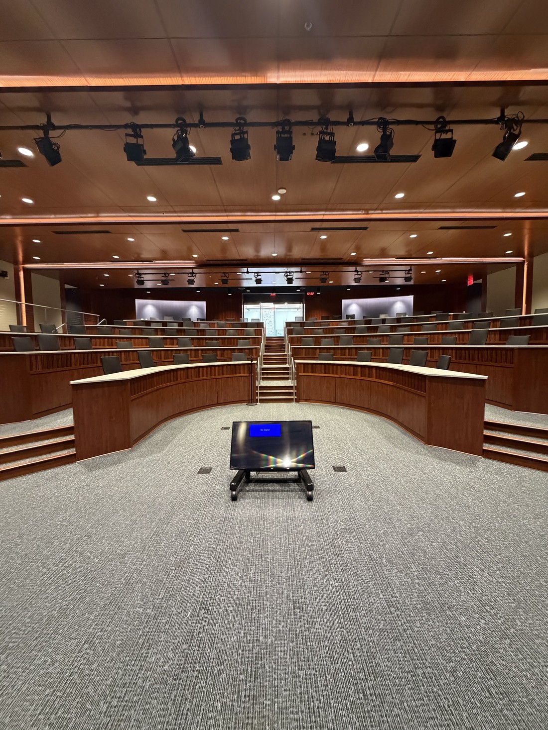 A tiered lecture hall at an HM Solutions account, cleaned and reset between sessions