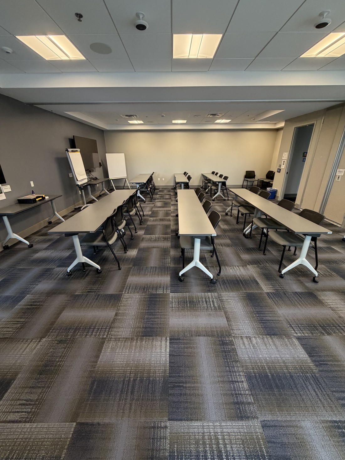 A campus training room with tables and chairs reset in rows