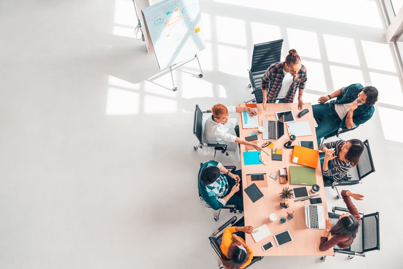A team gathered around a table working through a plan together